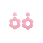 A pair of light pink bold and playful statement earrings in a retro-inspired daisy flower design. The earring has a large, light pink acrylic flower with a circular cutout center, hanging from a matching light pink circular stud. The petals are rounded, giving off a fun, 70's style far out vibe!!