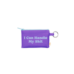 A super useful small zippered pouch featuring a gold key ring. The pouch has the saying "I Can Handle My Shit" written in light blue and the pouch color itself is a vibrant purple.