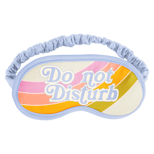 Blue bordered sleep mask with pink, pastel coral, orange, and green curved stripes that says "Do Not Disturb" on it. 