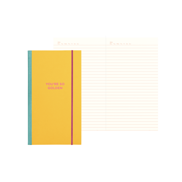 Yellow notebook with 'YOU'RE SO GOLDEN' on the cover and lined pages inside.