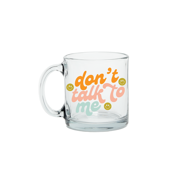 Colorful "dont talk to me" text on a glass mug with smiley faces