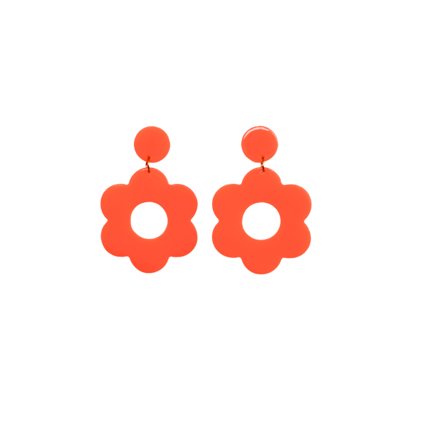 A pair of red bold and playful statement earrings in a retro-inspired daisy flower design. The earring has a large, red acrylic flower with a circular cutout center, hanging from a matching pink circular stud. The petals are rounded, giving off a fun, 70's style groovy vibe!!