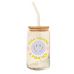 A clear can glass tumbler with lid and a clear straw. This clear can tumbler features a fun retro lavender smilie face in the center with the words " FUCK AROUND AND FIND OUT" written in citron color and two pink daisy's next to the smilie face.