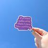 A hand holding a sticker with a glitter boarder and a purple background with the spot on saying 