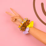 Trippy Dippy Scrunchie Set (3-Pack)
Add instant good vibes to your look with this bold, retro scrunchie trio. Each scrunchie features a playful, nostalgic pattern—chocolate brown smiley faces, neon yellow color blocking, and funky floral checkers in lavender and gold. Whether you're rocking them in your hair or on your wrist, these soft, stretchy accessories are perfect for adding personality to your outfit. Great for gifting or keeping all to yourself!