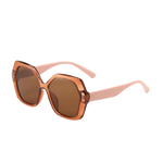A pair of retro-inspired design, oversized hexagonal sunglasses with dark brown tinted lenses and translucent brown frames with blush colored arms. 