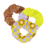 Trippy Dippy Scrunchie Set
This playful 3-pack of scrunchies features bold, retro-inspired patterns that make a statement. One has chocolate brown with pastel smiley faces, another showcases a neon yellow and lavender color block design, and the third bursts with groovy 70s-style yellow daisies over a lavender checkered pattern. The perfect accessory to add a fun pop to any outfit or hairstyle.