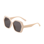A pair of retro-inspired design, oversized hexagonal sunglasses with dark brown tinted lenses and cream colored frames and arms.