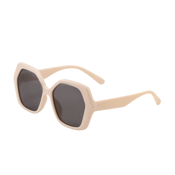 A pair of retro-inspired design, oversized hexagonal sunglasses with dark brown tinted lenses and cream colored frames and arms.