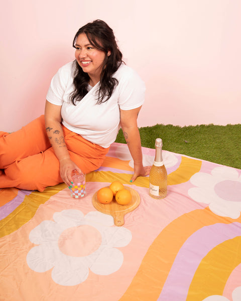 Soak up the sun with the ultimate picnic companion. This vibrant, retro-inspired blanket features bold florals and cheerful colors that instantly brighten any outing. Crafted for comfort and easy cleanup, it’s spacious enough for snacks, sips, and your favorite people. Whether you're lounging on the lawn or celebrating under the sun, this blanket brings the good vibes—and looks cute doing it.