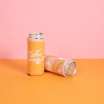 Cute reversible slim can holder with "Who Cares" on one size in orange and pink trimming and on the other side has a wavy rainbow with orange, periwinkle, and citron with cute fun daisies scattered around