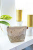 Canvas toiletry bag with leather tab detail and metal zipper, gold wrapped hills with moon and stars