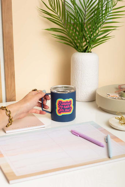 Desk setup with "I washed my hair for this?" camp mug, 2 TOOT pens, 1 small notepad, and 1 extra large weekly notepad. 