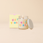 Glass jar candle reading "NOT TODAY" in multi-candle text. Box packaging with same text as candle. 