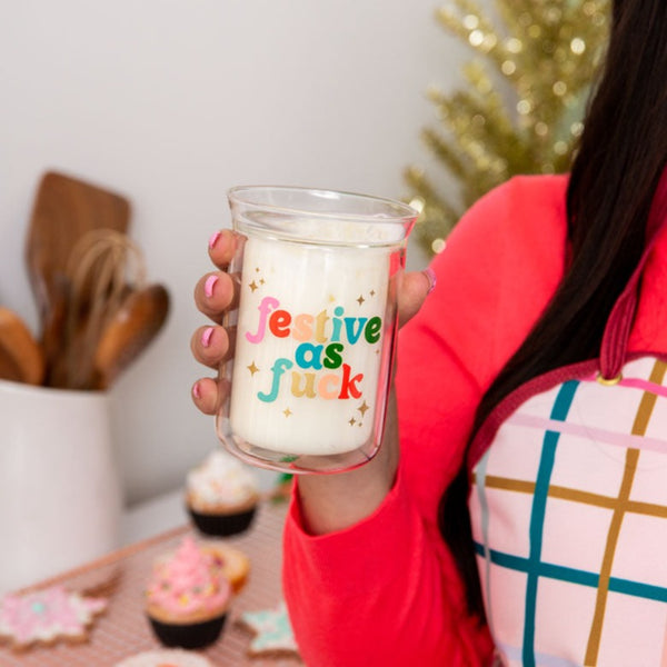 Clear candle with "festive as fuck" on text. 