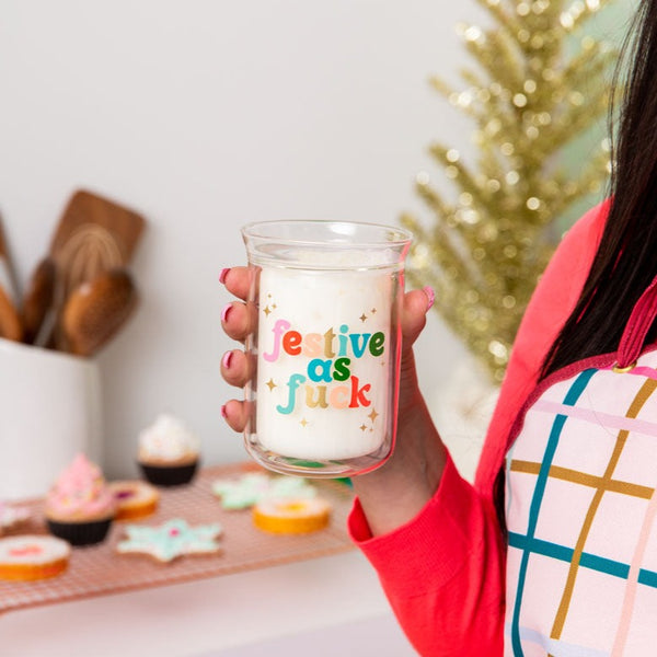 Clear candle with "festive as fuck" on text.