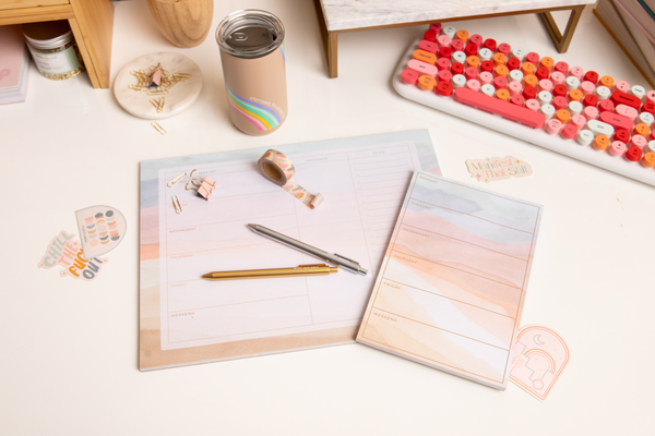 A Tearaway desk pad with a abstract sunset stipe pattern. Weekday format is included.