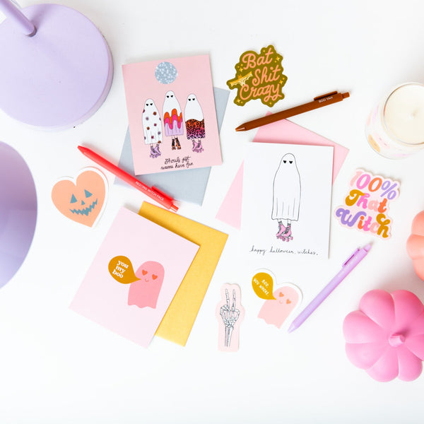 Halloween greeting cards in 3 variations; Halloween greeting card with pink ghost and word bubble saying "you my boo"; Greeting card with 3 ghosts in various designs under a disco ball saying "ghouls just want to have fun"; Greeting card with ghost in roller skates saying "happy halloween, witches"