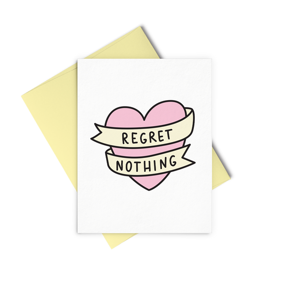 Regret Nothing is a cute greeting card with a pink bannered heart and a yellow envelope.