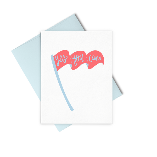 Yes You Can is an encouraging greeting card with a coral and blue flag and a blue envelope.