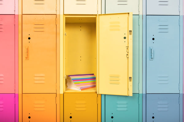 All different astrology notebooks inside a yellow locker among other colorful lockers