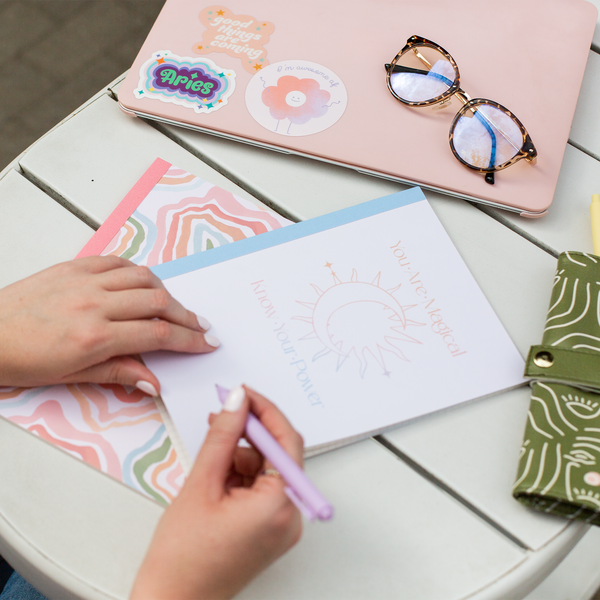 Notebook Set. 1st Notebook Gradient colored Sun and Moon outlined icon with gradient You Are Magical, Know Your Power Text. 2nd Notebook Multi Colored abstract squiggly circle all over pattern.