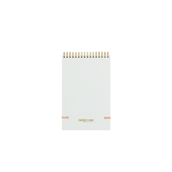 manifest that shit taskpad back with gold wire binding and peach colored elastic strap for closure