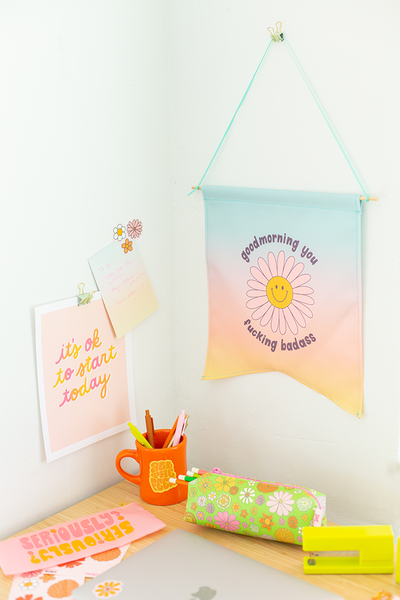 set up of desk with hanging pendant with poster and notes hung on wall