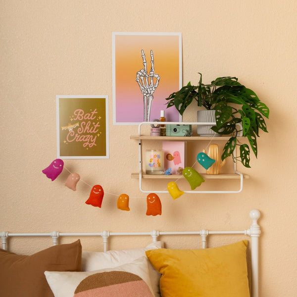 Halloween poster in 2 variations; Halloween poster ombre coral pink to purple 12x16 poster with skeleton peace sign in the middle; Olive green 8x10 poster with light pink lettering saying "bat shit crazy" with ombre yellow to white bat and star sparkle