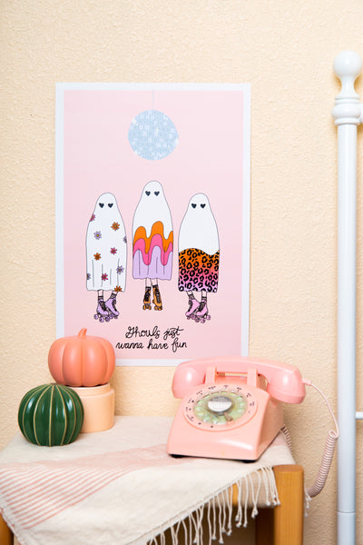 Pink 13x19 poster with three ghosts in patterned sheets and a disco ball above them; "ghouls just wanna have fun" is written at the bottom.