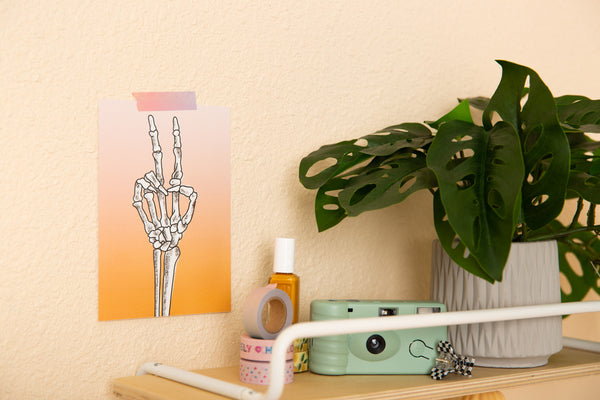 ombre coral pink to purple 5x7 poster with skeleton peace sign in the middle.