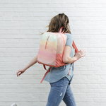 a girl wearing a ripstop backpack with a pastel gradient print.