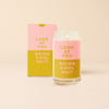 Pink and yellow decal on 16 oz can glass that reads 